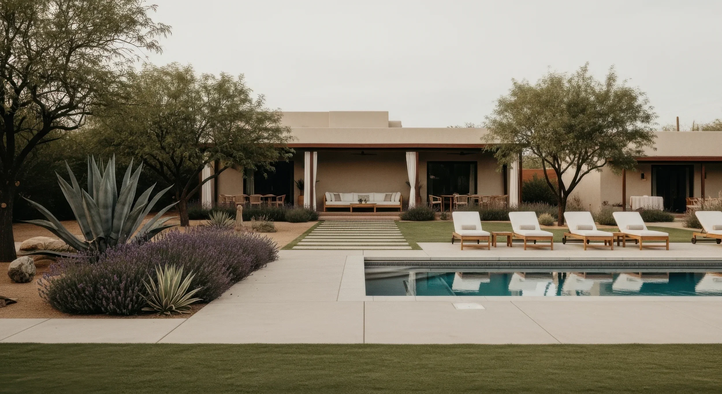 Custom outdoor lounge and dining furniture beside the pool at a private desert estate in Scottsdale, Arizona