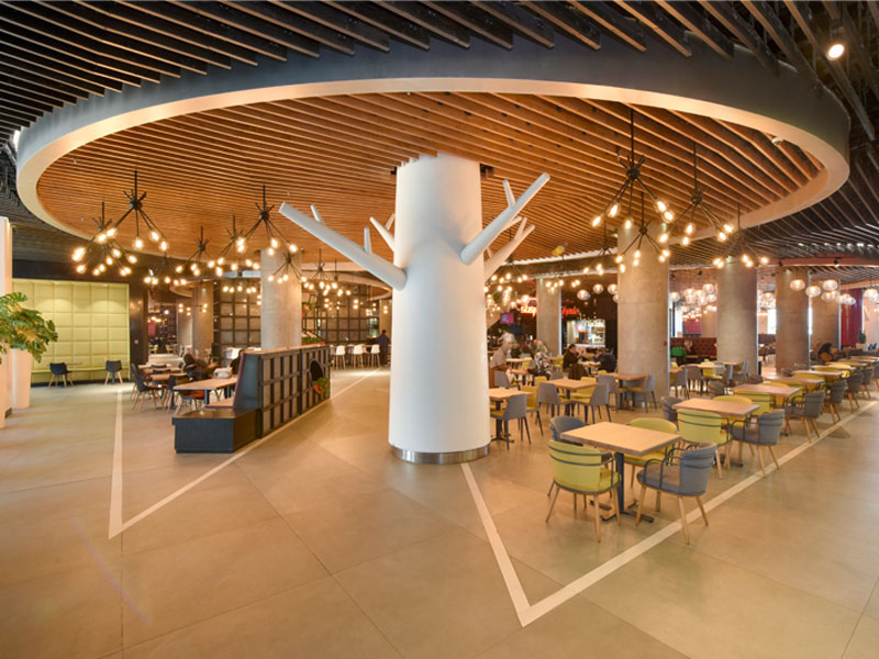 Repeatable food hall seating modules under a custom canopy