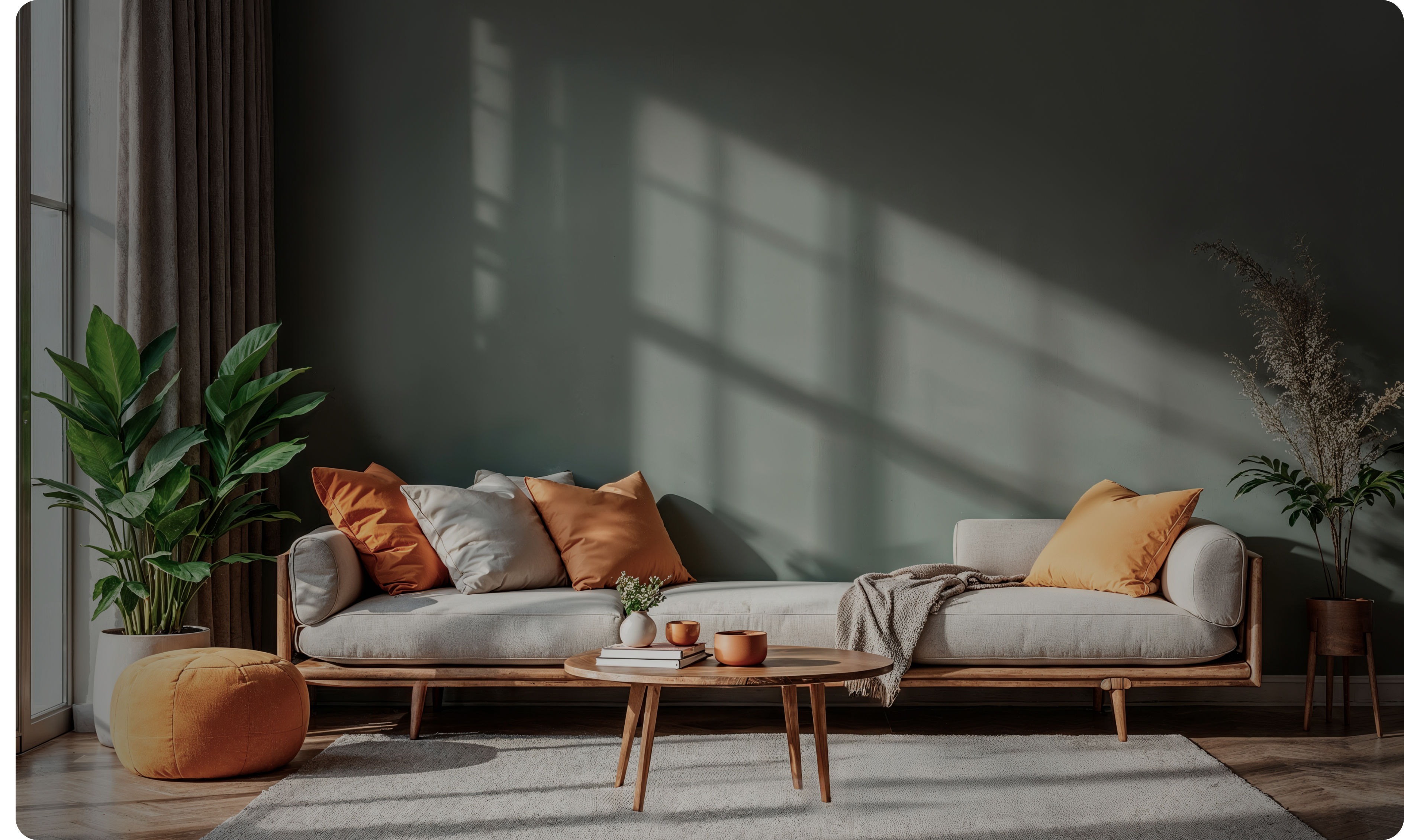 Wood-framed sofa with linen cushions and a round coffee table in a finished interior
