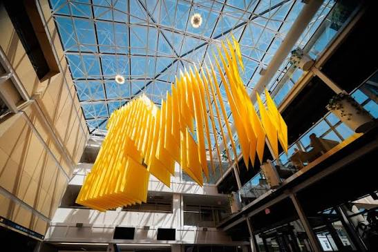 Custom suspended sculptural artwork installed above an atrium at the University of Michigan