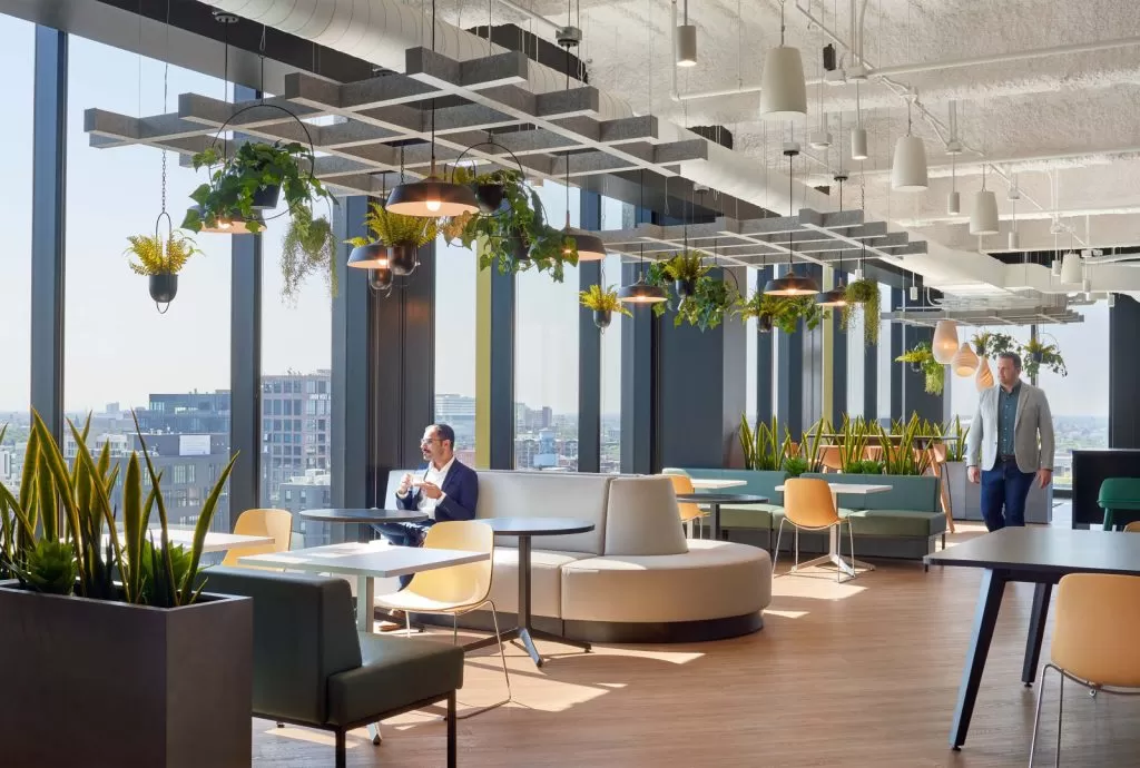 Hospitality-style workplace lounge with informal seating and city views